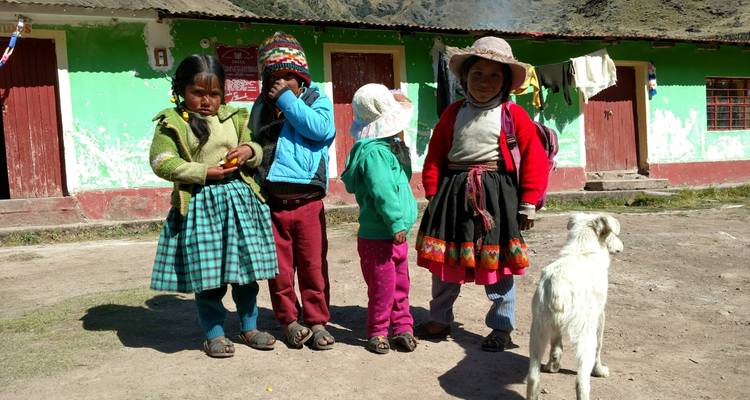 Local family standing outside a colorful building with a dog.