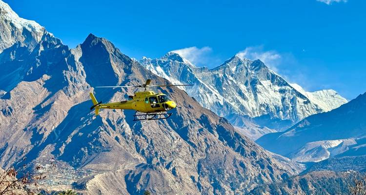 Helicopter flying over majestic mountain range
