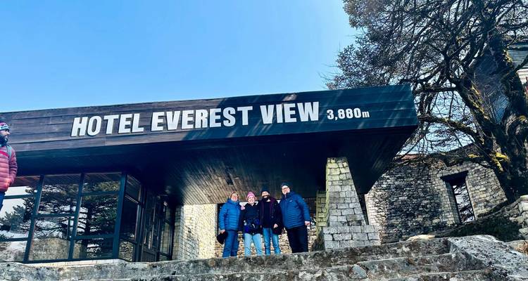 Group of people standing in front of the Hotel Everest View sign.