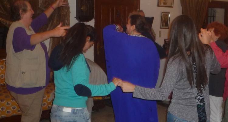 People dancing and enjoying a social gathering indoors.