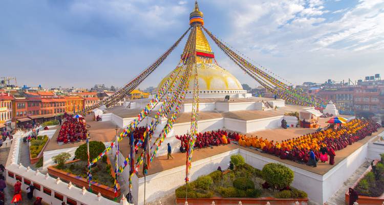 Boudhanath Stupa surrounded by people during a ceremony.