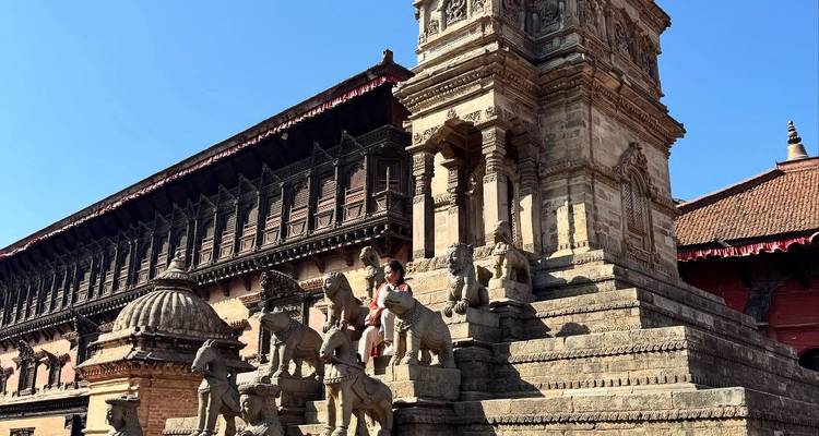 Historische Tempelstufen mit Statuen und traditioneller Architektur.