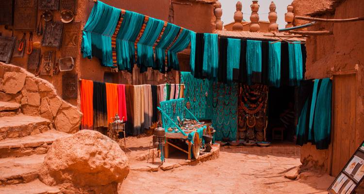 Market with colorful textiles in Morocco.