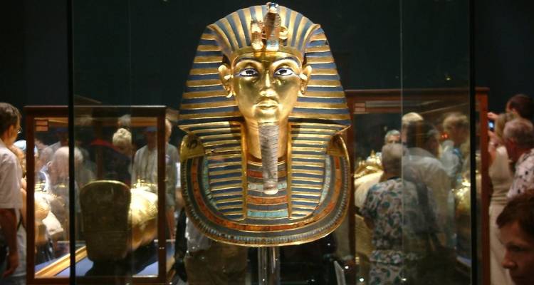 Tutankhamun's golden mask on display in a museum.