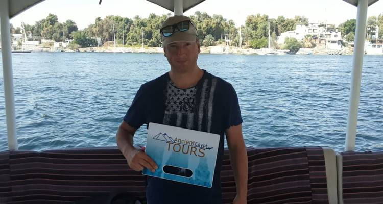 A person holding a tour sign on a boat.