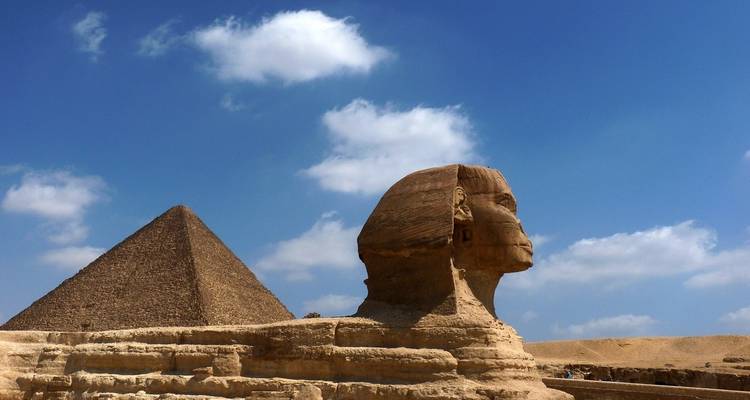 The Sphinx and Pyramid under a few clouds.