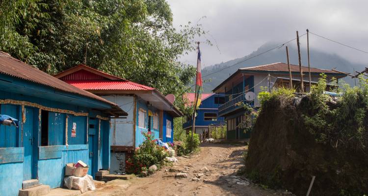 Rural road through a village with colorful buildings.