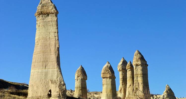 Tall rock formations under a clear blue sky.