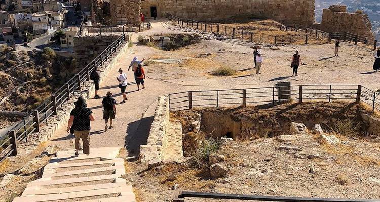 Besucher, die an einem sonnigen Tag um eine historische Stätte herumgehen.