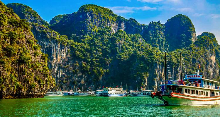 Halong Bay with its limestone islands and multiple boats.