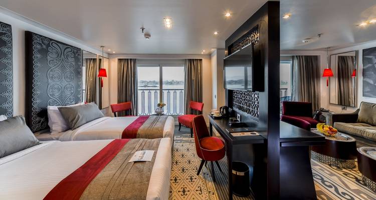 Interior of a luxurious cruise cabin with river view.