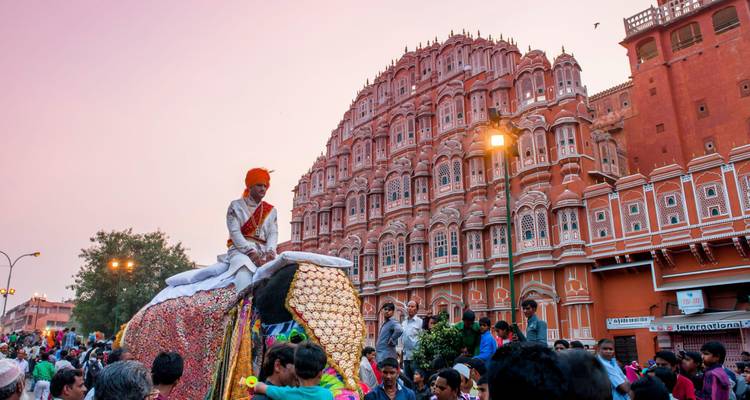 Procession in front of the Hawa Mahal, with a man on a decorated elephant.