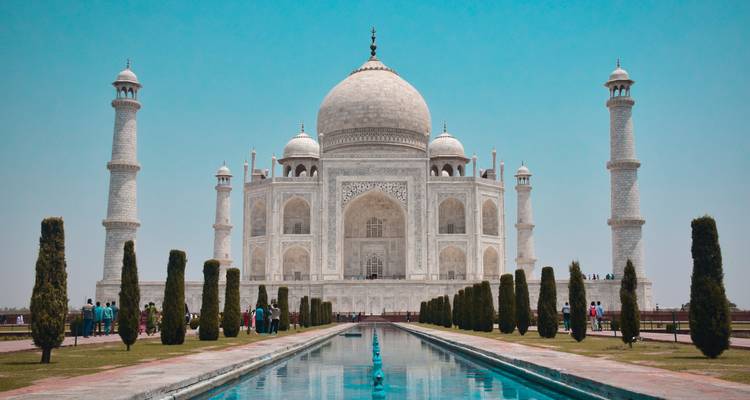 Das Taj Mahal von vorne betrachtet mit Gärten und Wasserbecken.