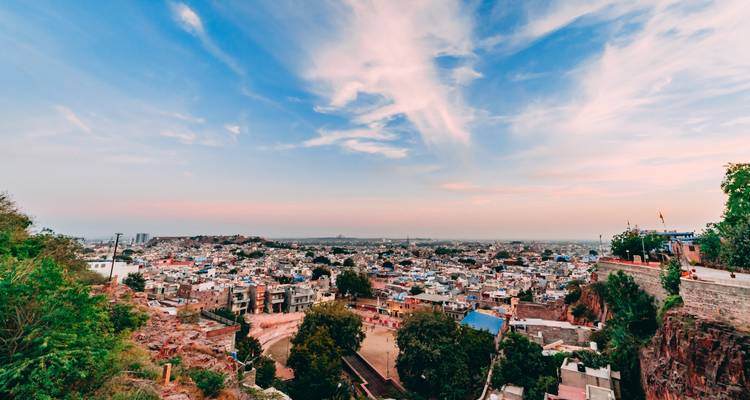 Uitzicht over een stad onder een kleurrijke hemel.