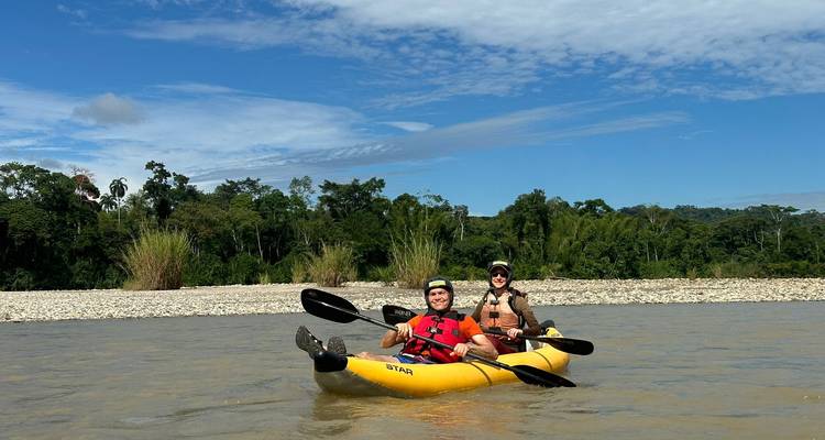 Two people in a kayak paddling down the river.