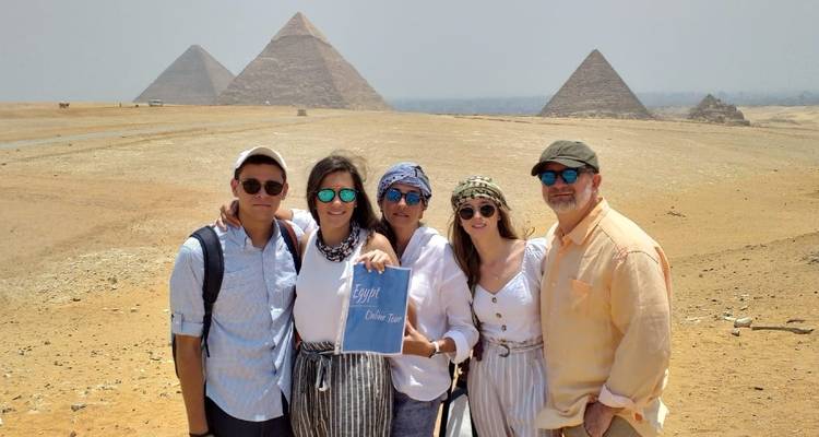 Family posing with the Pyramids of Giza in the background.