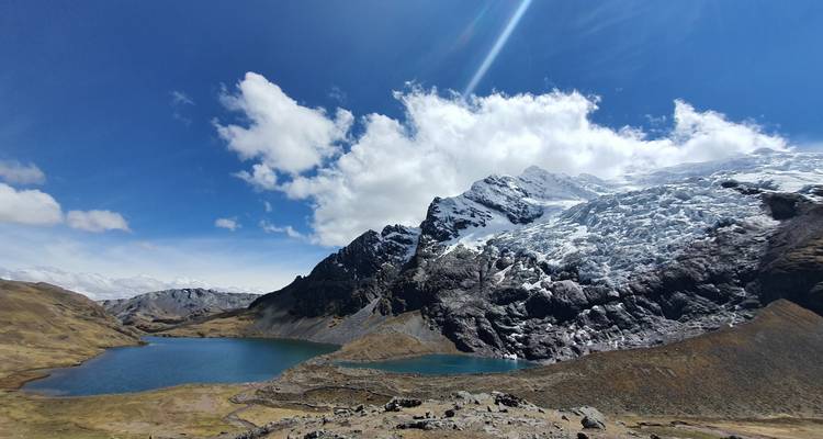 Lac glaciaire entouré de montagnes enneigées.