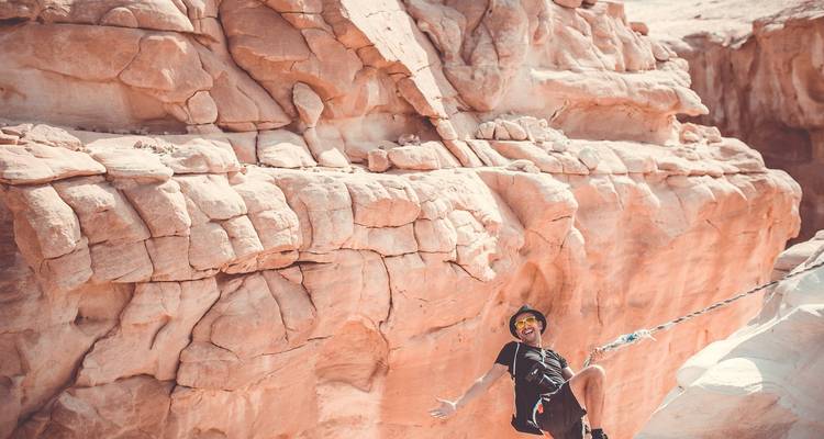 Person rock climbing in a canyon.