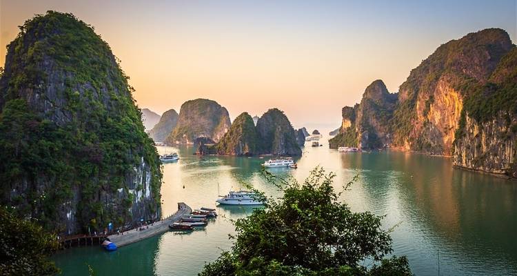 Scenic view of Halong Bay with boats and limestone islands.