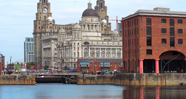 Vue à travers la Mersey sur le front de mer historique de Liverpool dominé par le Royal Liver Building et l'architecture portuaire.