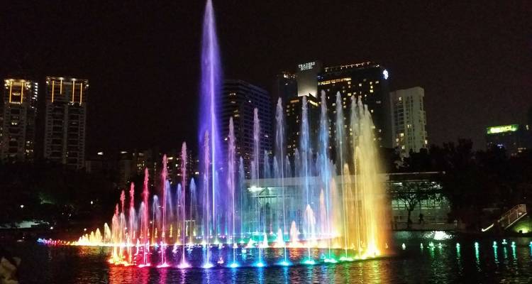 Colorful fountain display in a city at night.