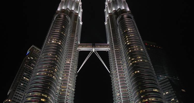 Petronas Towers illuminated against the night sky.