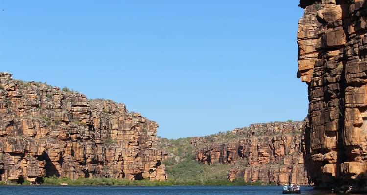 Gorge with steep rocky walls and water at the base.