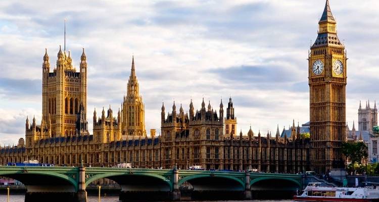 Classic view of Big Ben and the Houses of Parliament across Westminster Bridge in soft evening light