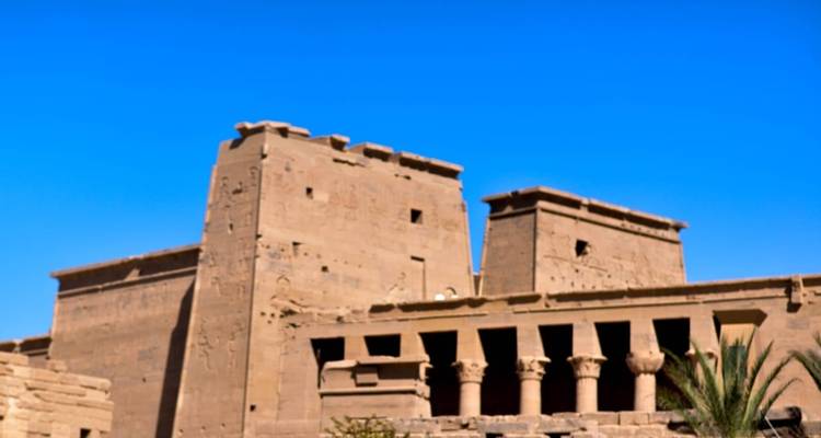 Ancient ruins with a clear blue sky in the background.