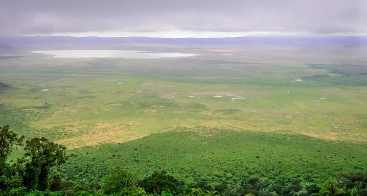 View of a vast landscape with a lake in the distance.