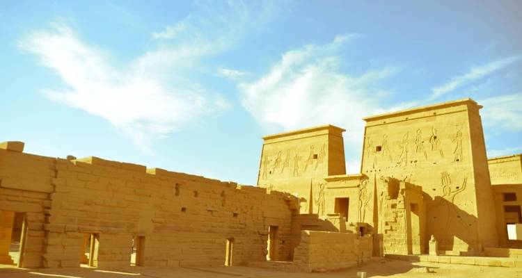 Sunlit ancient Egyptian temple with carvings.