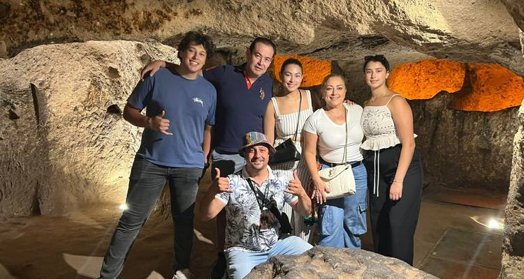Group of people posing inside a cave.