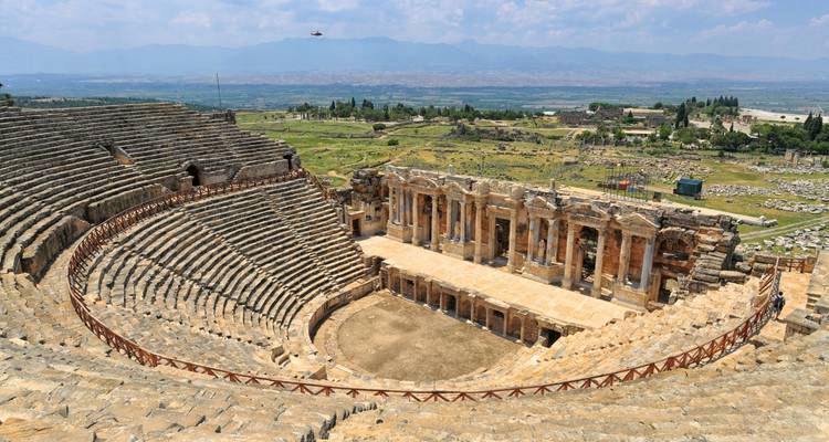 Ancient amphitheater with scenic background.