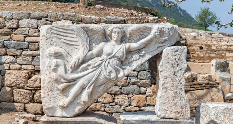 Ancient stone relief with an angel figure.