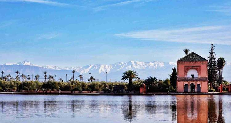 Reflektierende Seeszene mit einem Pavillon und schneebedeckten Bergen im Hintergrund