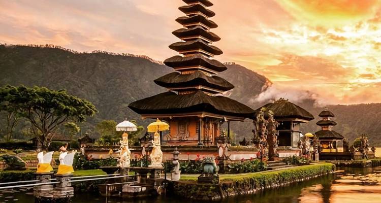 Temple with a large pagoda surrounded by water and hills.