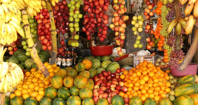 Colorful fruit market stall with various fruits.