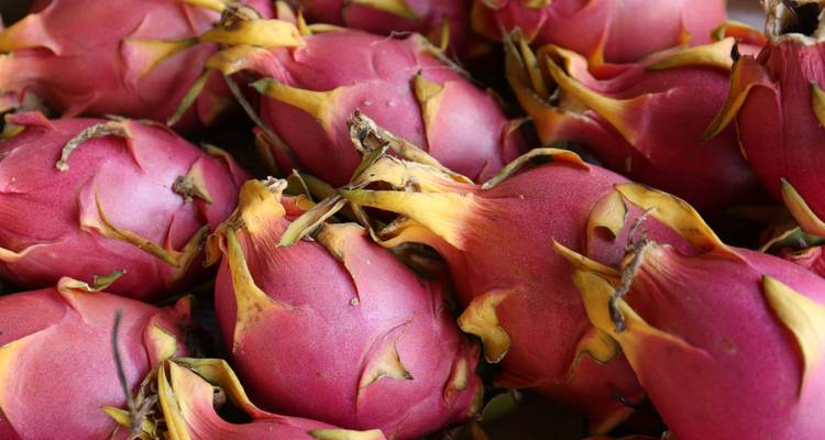 Close-up of dragon fruits piled together.