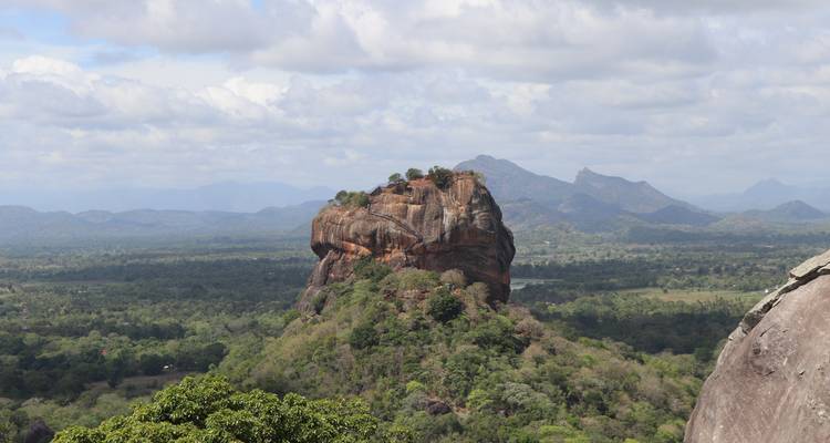View of the iconic Sigiriya Rock surrounded by forest.