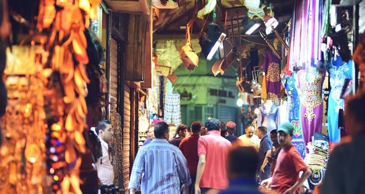 Vibrant market scene with various goods and people.