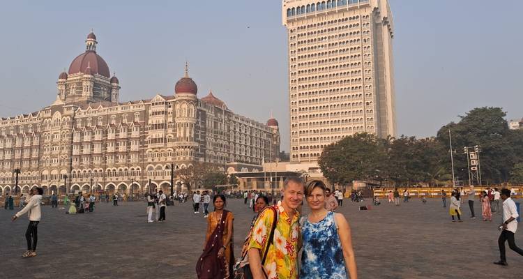 Couple posing in front of the Gateway of India and Taj Mahal Palace.