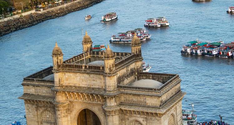 Aerial view of Gateway of India with boats in the background.