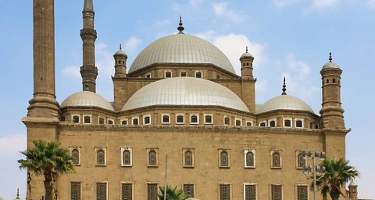 Exterior view of a large mosque with domes and minarets.