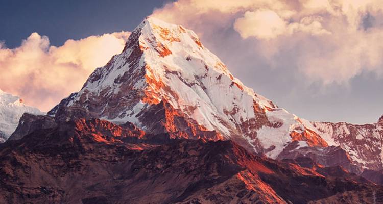 Nahaufnahme eines schneebedeckten Gipfels bei Sonnenuntergang