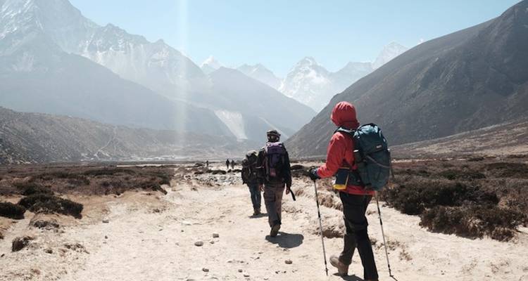 Hikers walking through a mountainous landscape.