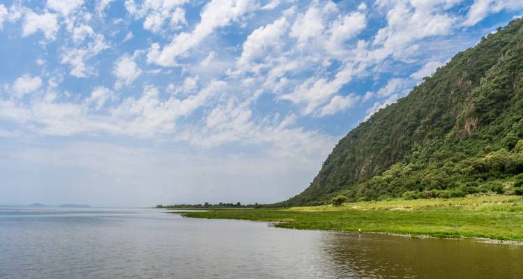 Water view with mountain and sky.