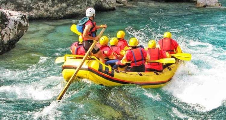Rafting adventure with a team navigating calm turquoise waters.