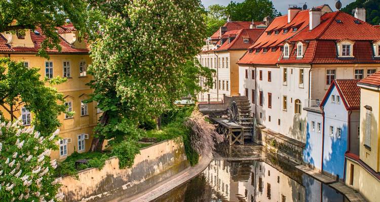 A scenic view of colorful buildings and a canal in Prague.
