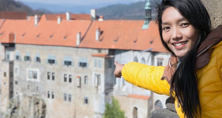A person pointing to the beautiful Cesky Krumlov town view.