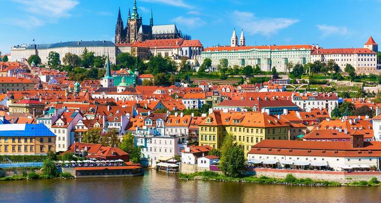 A breathtaking panoramic view of Prague with its iconic red roofs and Vltava River.